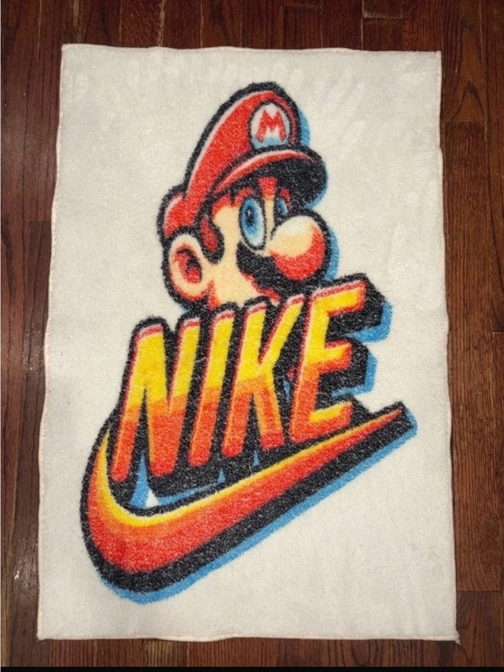 White Rug with Red, Orange, Yellow and Blue Mario Graphic